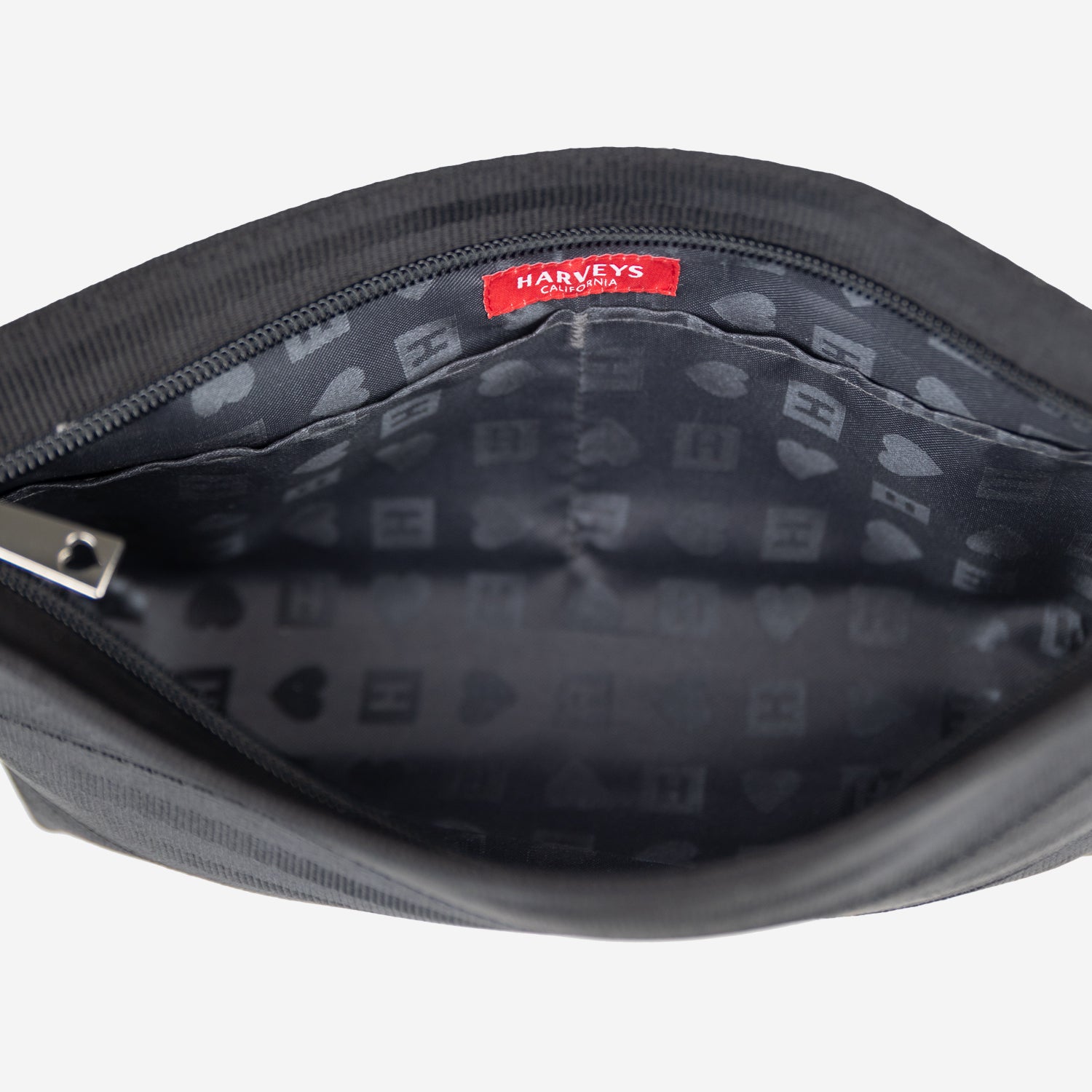 Black makeup bag lining interior with Harveys label on a white background
