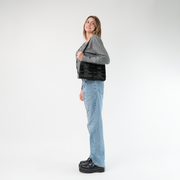 The Black Lola Bow Clutch being worn by a model