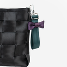 The Bow Keychain in Poison Ivy being used on a bag