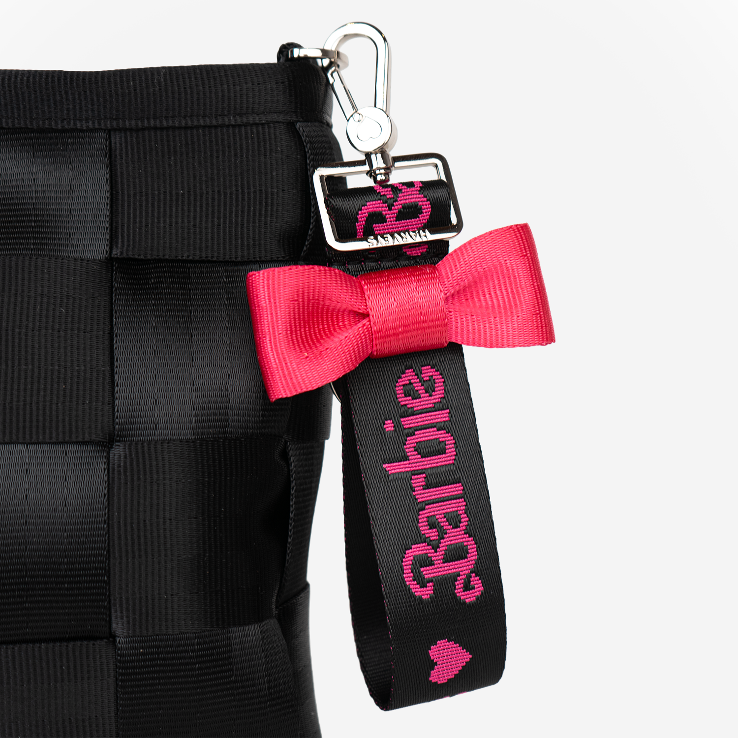 The Barbie Debossed Bow Keychain being used on a bag