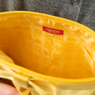 The inside of a Buttercup Lola Bow Clutch