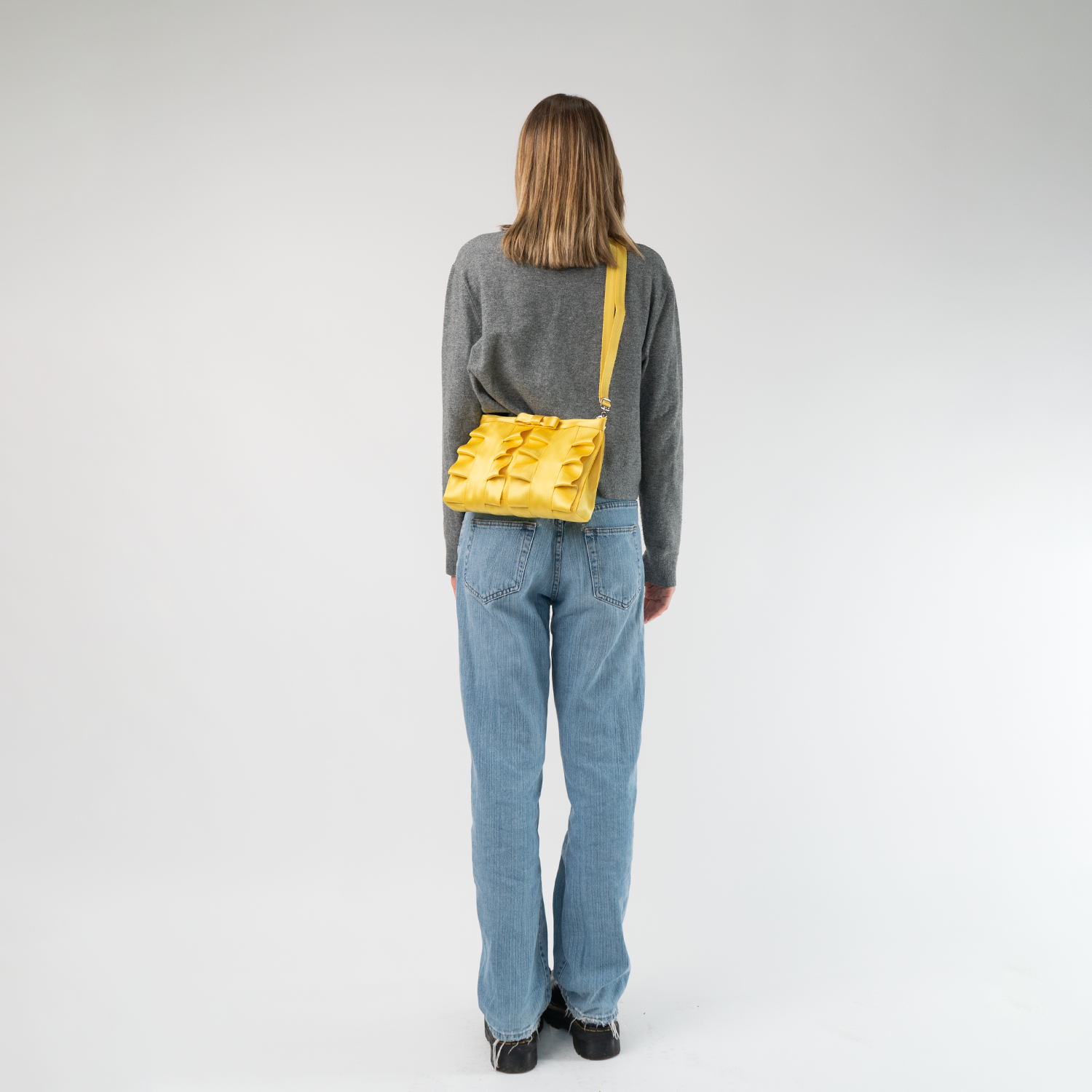 The Buttercup Lola Bow Clutch being worn by a model