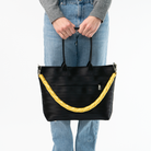 The Long Lola Click N Carry being used on a bag by a model