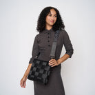 A model wearing a Black Widow 5 Panel Click N Carry with a bag