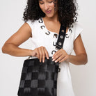 Model wearing 5 panel Click n Carry in grommet attached to black mini messenger
