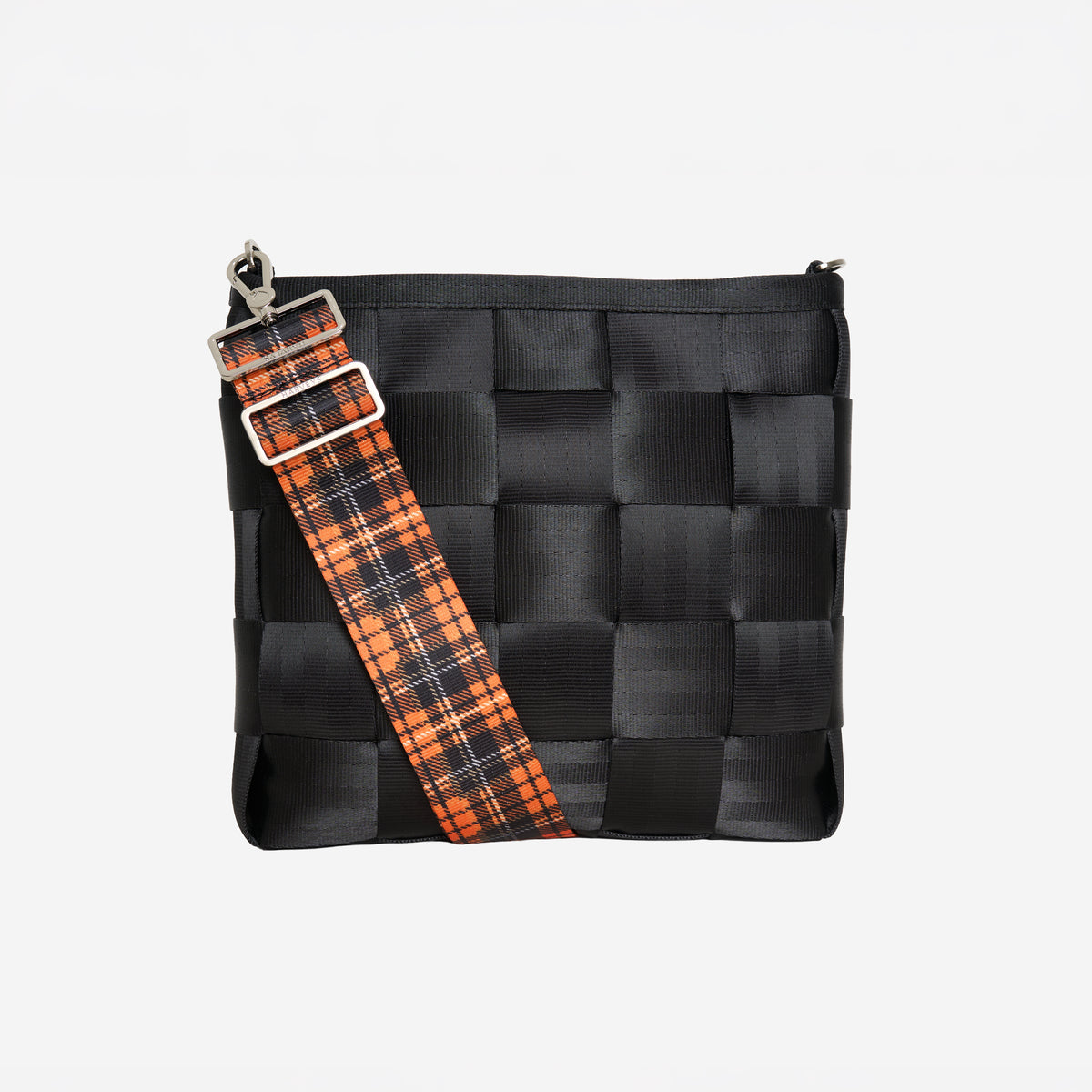 View of 5 panel  Click N Carry in Orange Tartan attached to black mini messenger