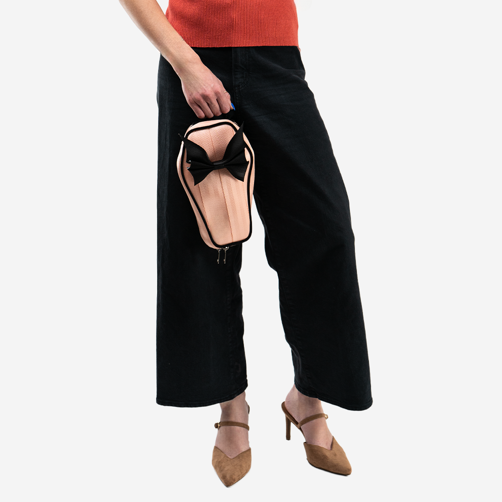A Cantaloupe Coffin Convertible Crossbody being held by a model.