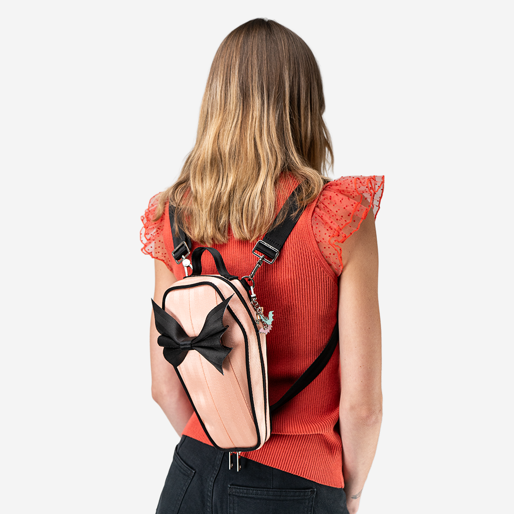 A Cantaloupe Coffin Convertible Crossbody being worn by a model.