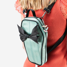 A Mint Coffin Convertible Crossbody being worn by a model.