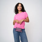 A model holding The Pink Agenda Pink Ribbon Coin Purse