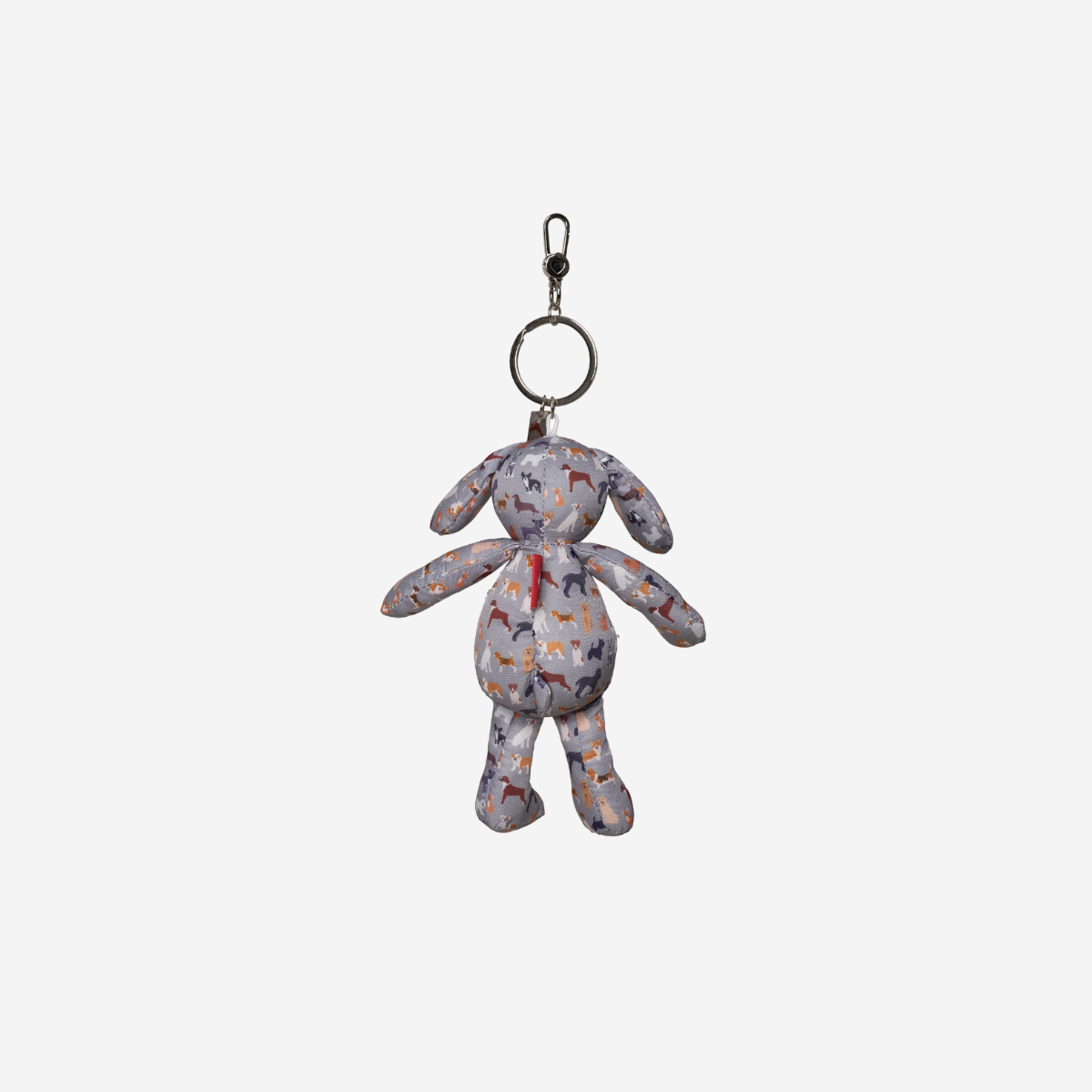 A small plush dog keychain with a multicolor abstract pattern on a light gray base, featuring a silver metal split ring and clasp at the top, shown against a plain light gray background.