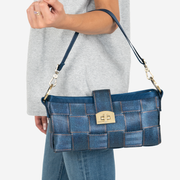 View of a Carriage Ring Baguette in Denim on a Models arm