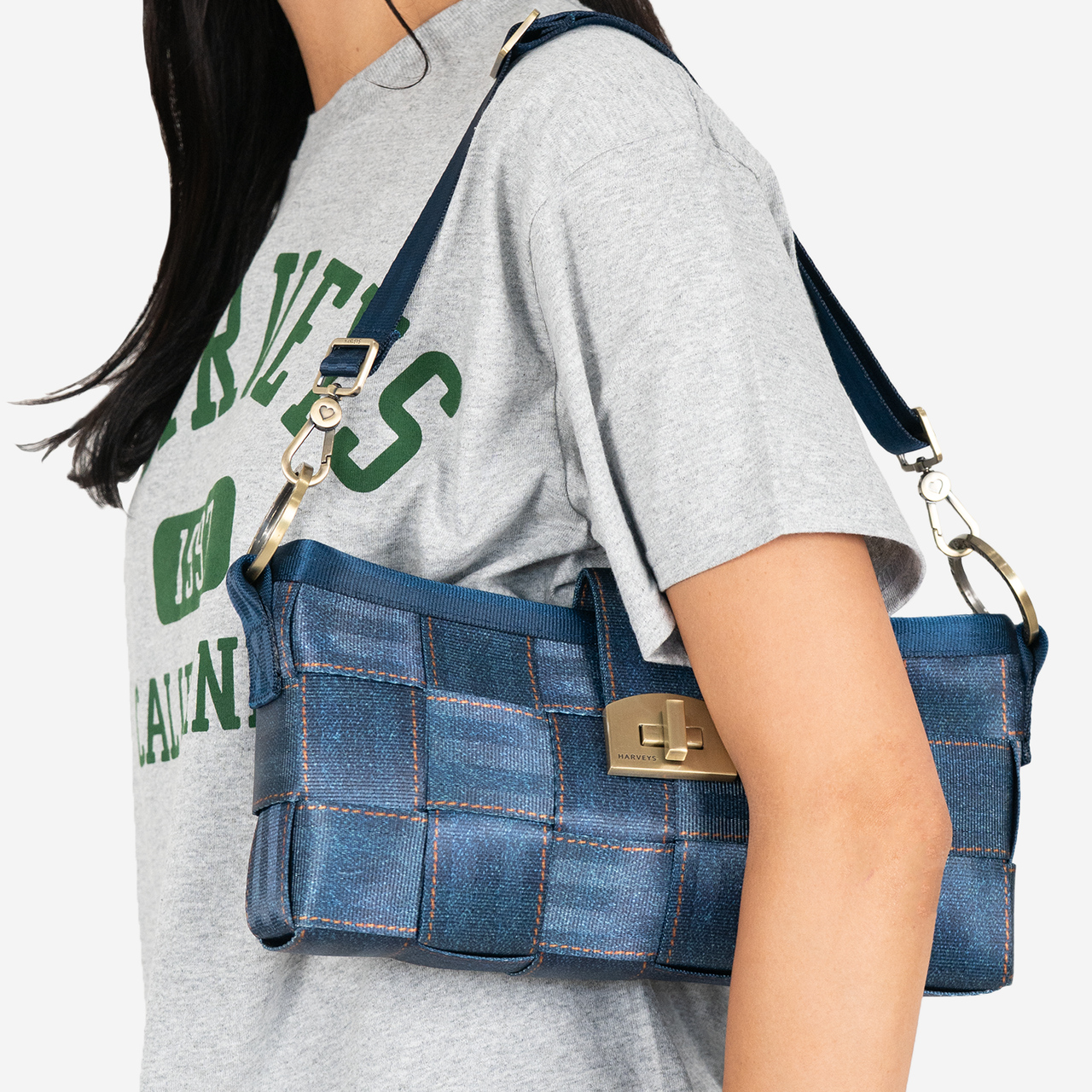 View of a Carriage Ring Baguette in Denim on a models shoulder