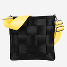 The 5 Panel Click N Carry in Lemon being used on a bag
