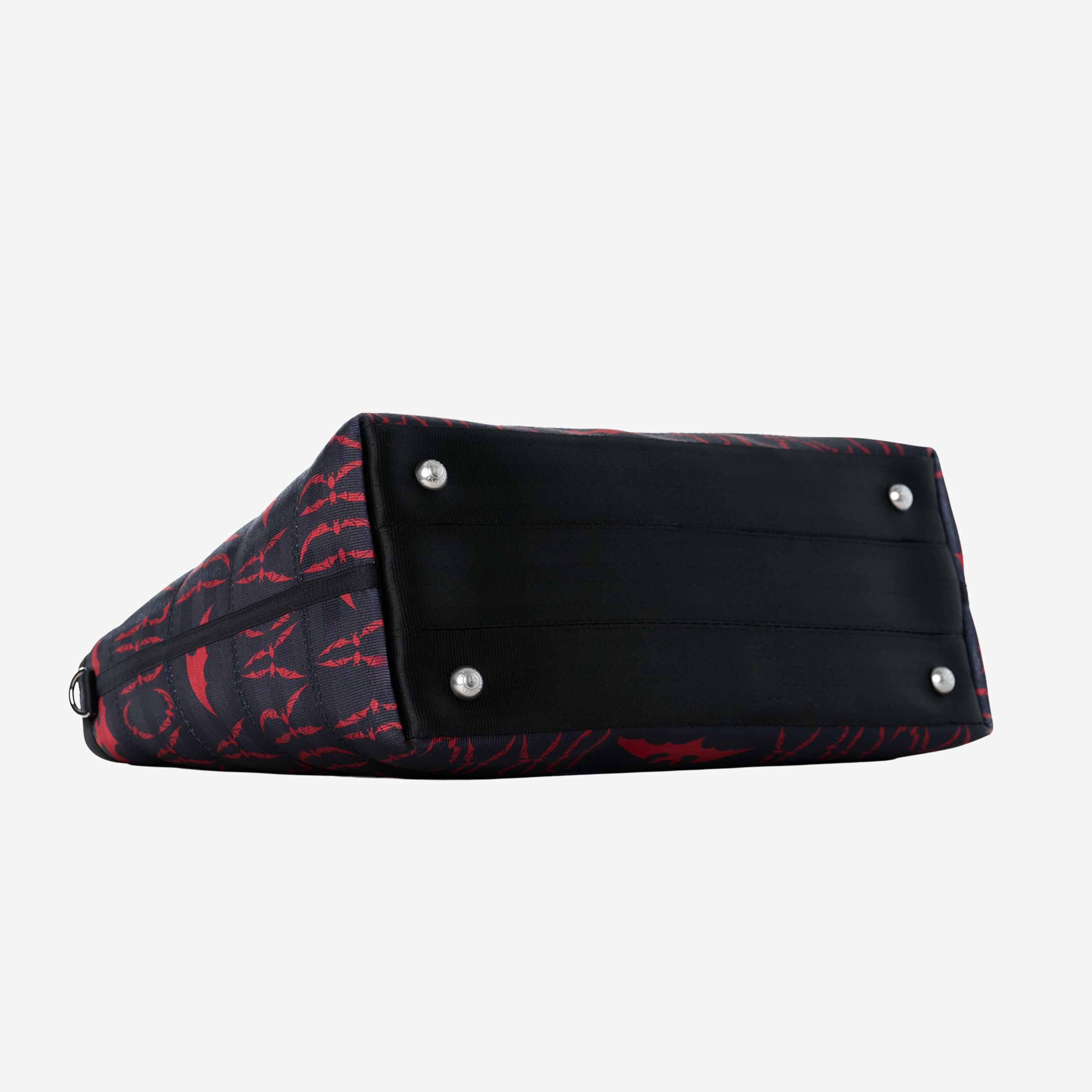 Bottom side of large bat tote with red Dracula lettering showing foot hardware