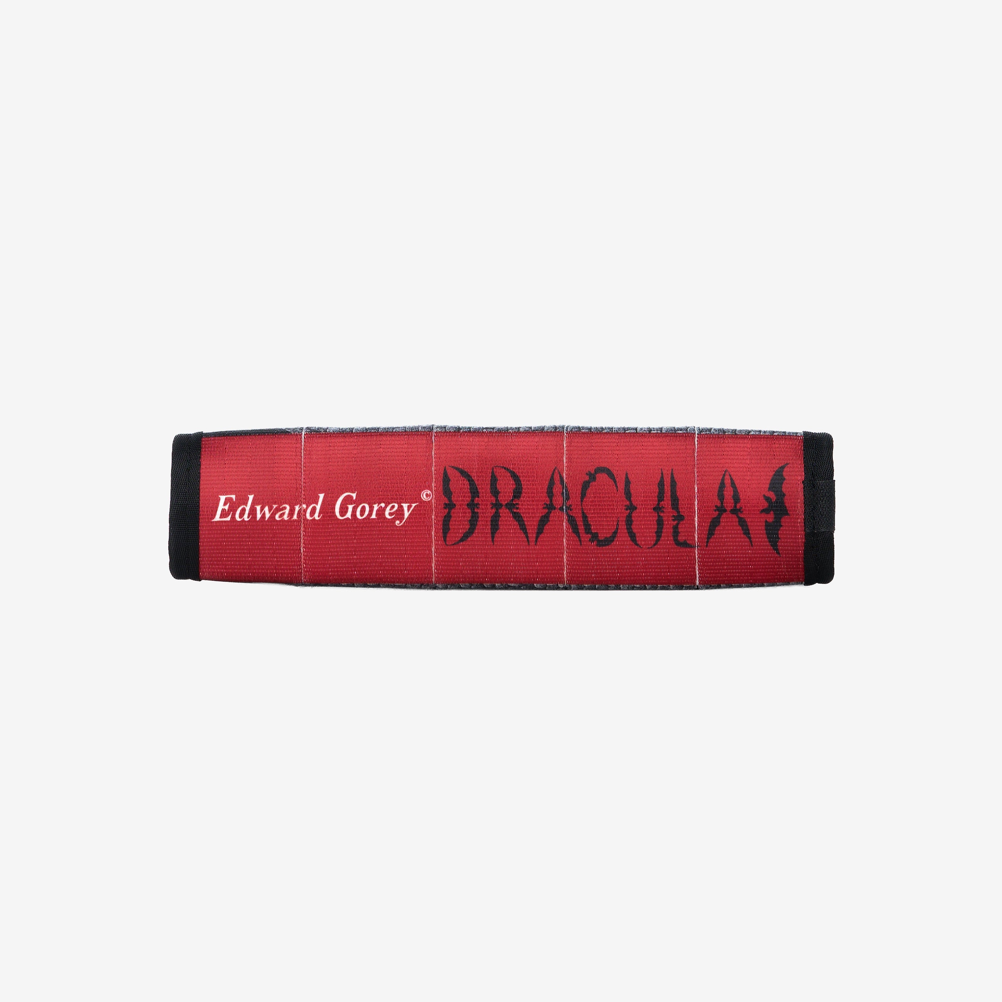side view of black crossbody book shaped  bag displaying red book spine