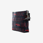 Side view of black clutch with red Dracula and bat lettering and silver bat charm