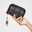 A model holding a Black Widow Fun Size Wallet