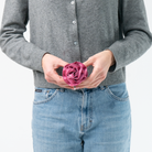 The Fuchsia Rosette being held in a model's hands