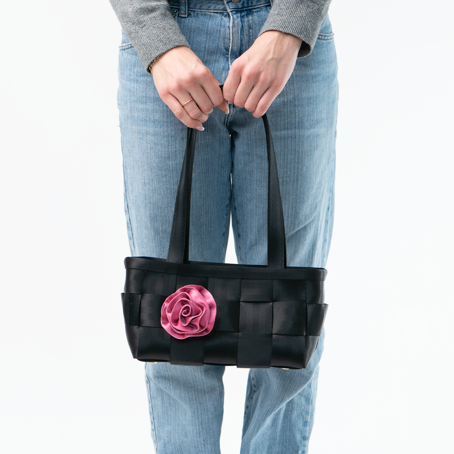 The Fuchsia Rosette being used on a bag by a model