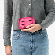 The Fuchsia Lola Fun Size Wallet being held in a model's hand