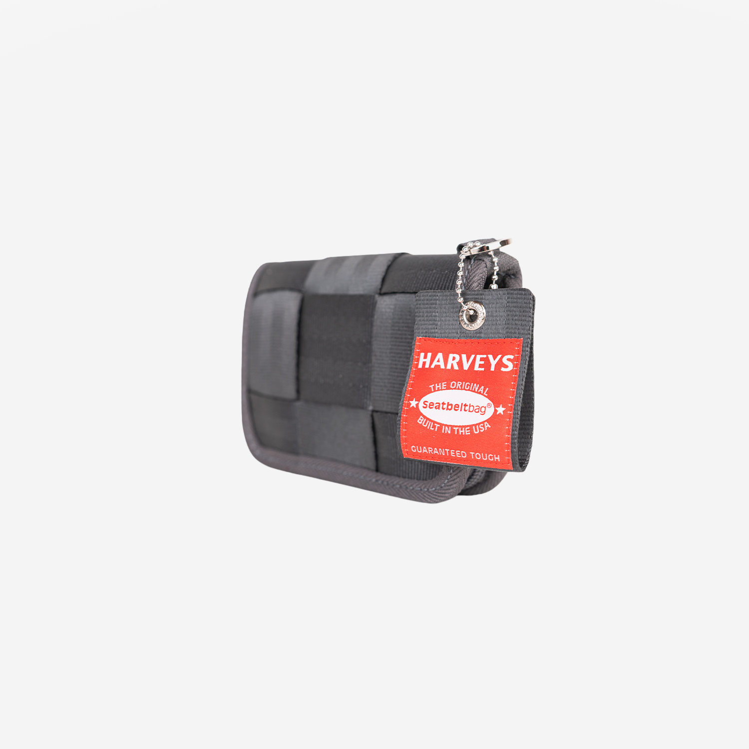 A gray woven Harveys seatbelt wallet with a red Harveys hangtag, shown on a light gray background.