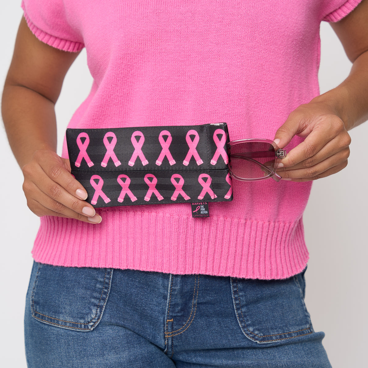 A model holding The Pink Agenda Pink Ribbon Glasses Case