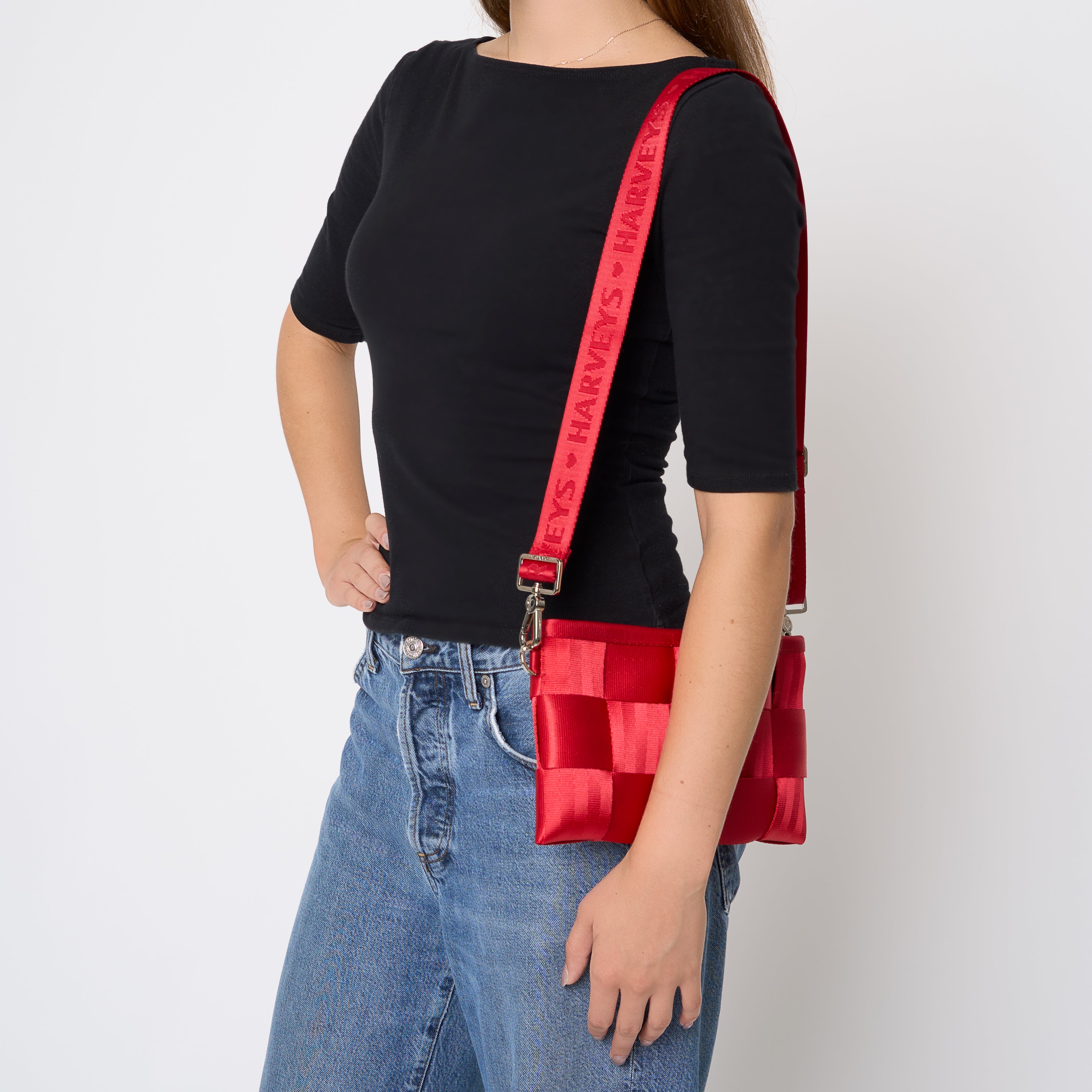 Hip Pack being worn on the should  by model with the strap extended to waist