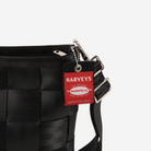 The Hangtag detail on a Mini Messenger in Black