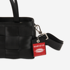 The Hangtag detail on a Woven Petite Tote in Black