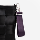 The 4 Panel Keychain in Blackberry being used on a bag