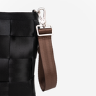 The 4 Panel Keychain in Espresso being used on a bag