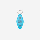A bright turquoise blue Key tag featuring a silver split ring. The Key tag is printed with  'Ken's Mojo Dojo Casa House Malibu, Ca.