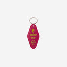 A magenta plastic Key Tag featuring gold foil text that reads 'Ward Barbie Dream House' and 'Played with too much,' attached to a silver metal key ring against a light gray background.