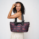 model holding large bat tote over shoulder front of bag