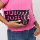 A model holding The Pink Agenda Pink Ribbon Large Makeup Case