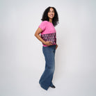 A model wearing The Pink Agenda Pink Ribbon Medium Convertible Clutch
