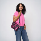 A model wearing The Pink Agenda Pink Ribbon Medium Convertible Clutch