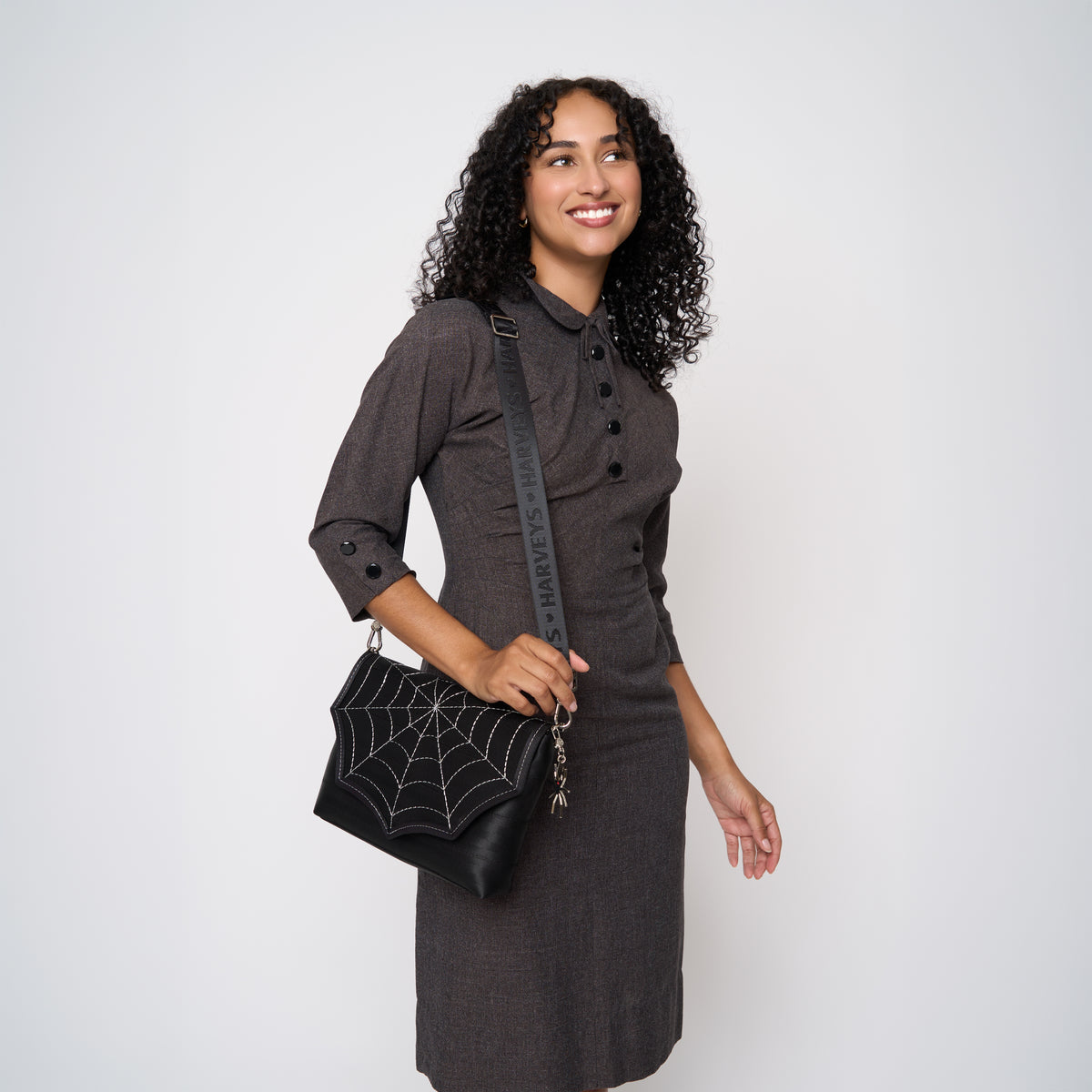 A model wearing a Black Widow Medium Foldover Crossbody 