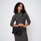 A model wearing a Black Widow Medium Foldover Crossbody 