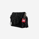 The side view of The Black Widow Medium Foldover Crossbody Collector's Series