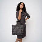 A model wearing a Black Widow Medium Streamline tote 