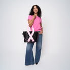 A model wearing The Pink Agenda Pink Ribbon Medium Streamline Tote