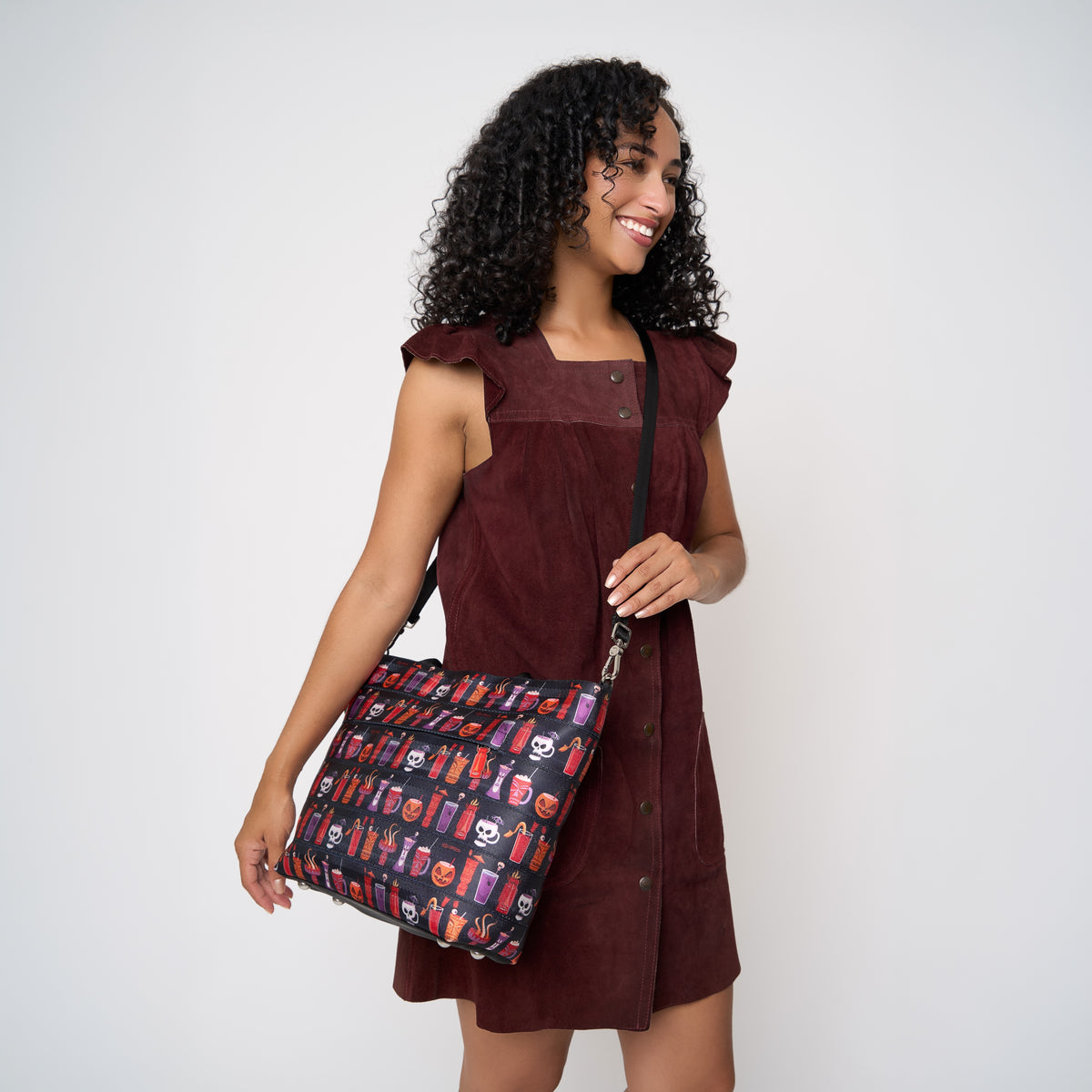 Model using extendable black strap to wear Medium Streamline Tote Shag Spooky Tiki Cocktail