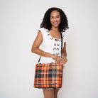 Model carrying Medium Streamline Tote in orange tartan with adjustable black strap