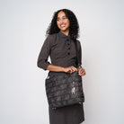 A model wearing a Black Widow Medium Streamline tote 