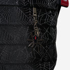 The charm detail of a Black Widow Medium Streamline Tote 