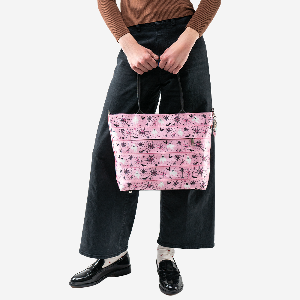 A Pink-A-Boo Medium Steamline Tote being worn by a model.