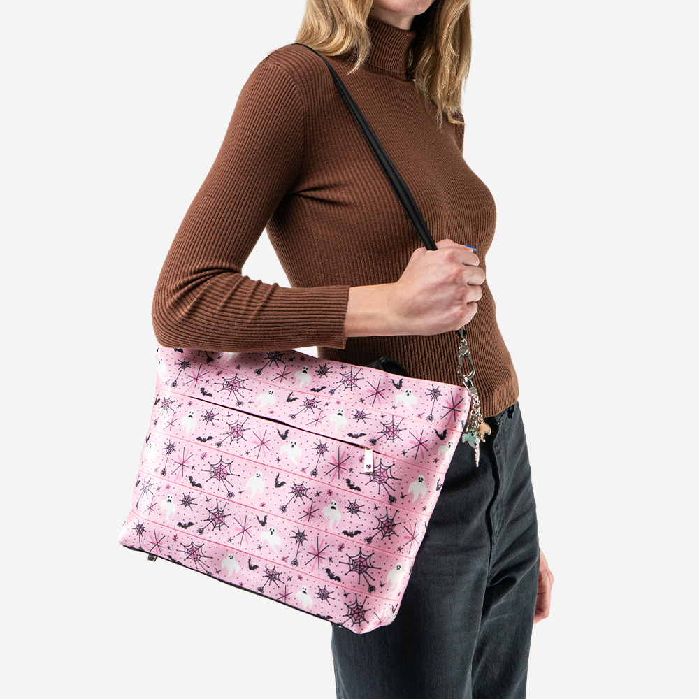 A Pink-A-Boo Medium Steamline Tote being worn by a model.