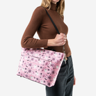 A Pink-A-Boo Medium Steamline Tote being worn by a model.